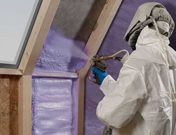 person applying spray foam insulation